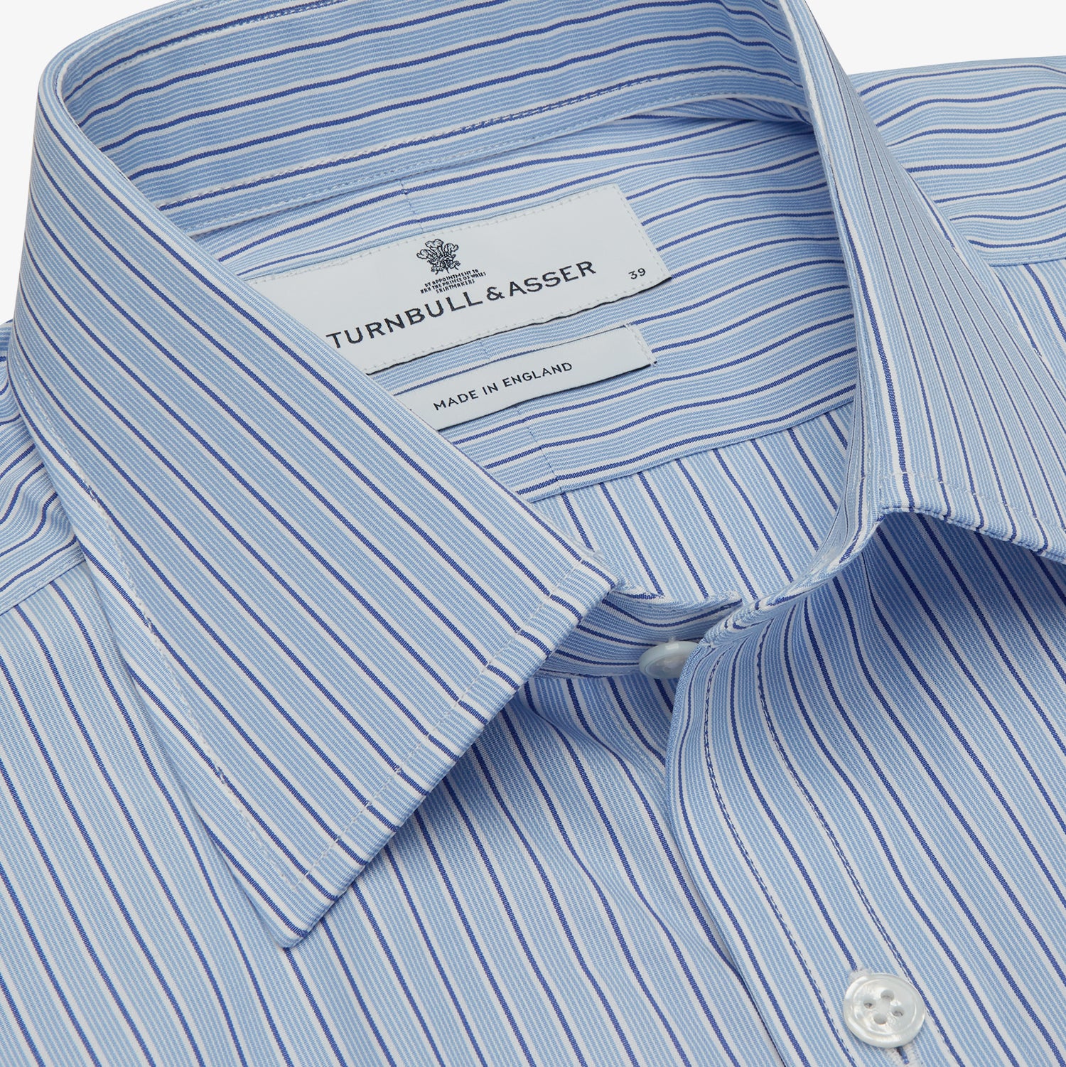 View 4 of product Turnbull & Asser’s Blue Stripe Shirt features thin vertical white stripes, a T&A collar, 3-button cuffs, white buttons, and a regular fit. Smart-casual style displayed flat on a white background.