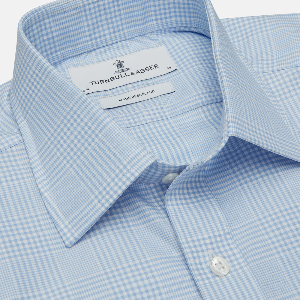The Turnbull & Asser Pale Blue Check Shirt features a T&A collar, 3-button cuffs, and a subtle tonal check in royal cotton twill. It’s long-sleeved, regular fit, and shown flat on a white background.
