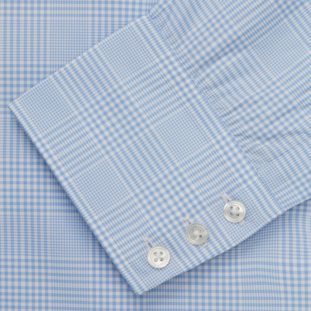 The Turnbull & Asser Pale Blue Check Shirt features a T&A collar, 3-button cuffs, and a subtle tonal check in royal cotton twill. It’s long-sleeved, regular fit, and shown flat on a white background.