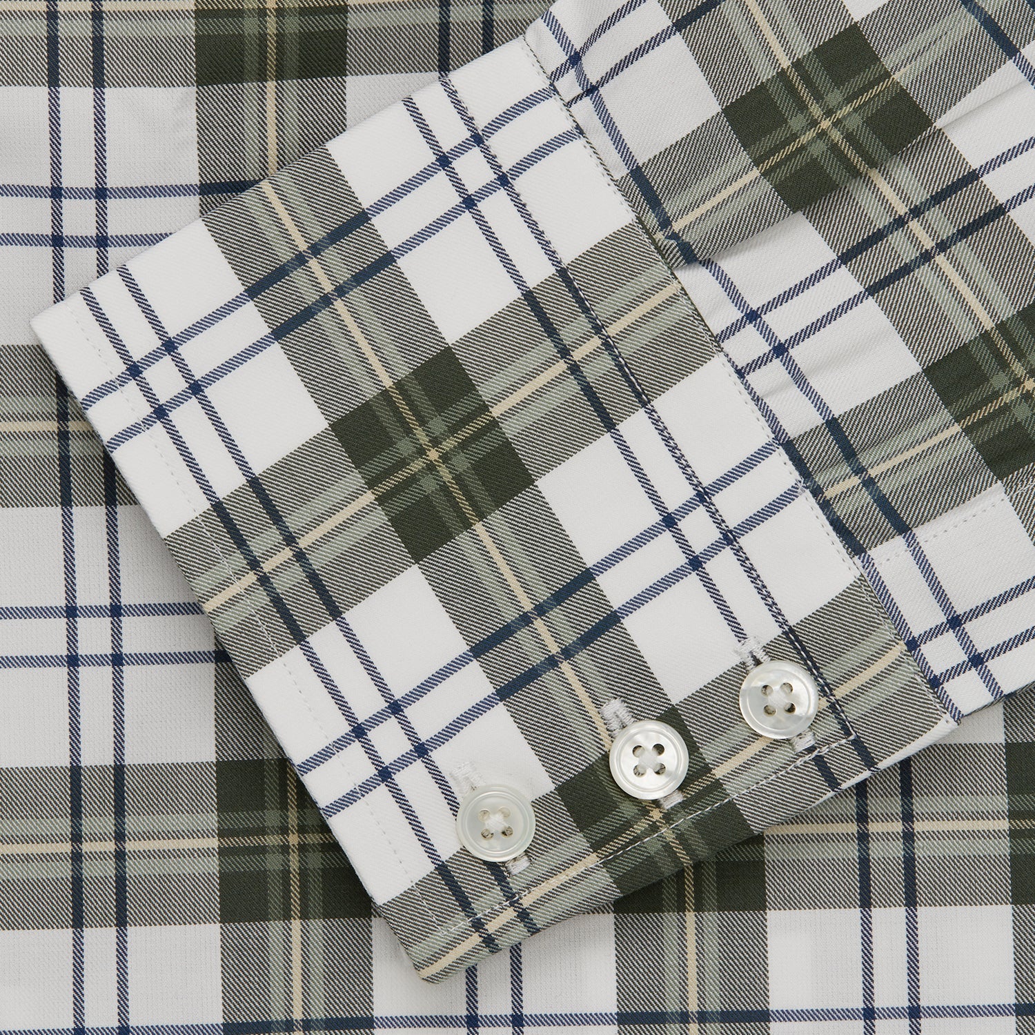 View 5 of product The Turnbull & Asser Green Check Shirt features a classic T&A collar, white buttons down the front and on 3-button cuffs, and a bold green, white, and black plaid pattern.