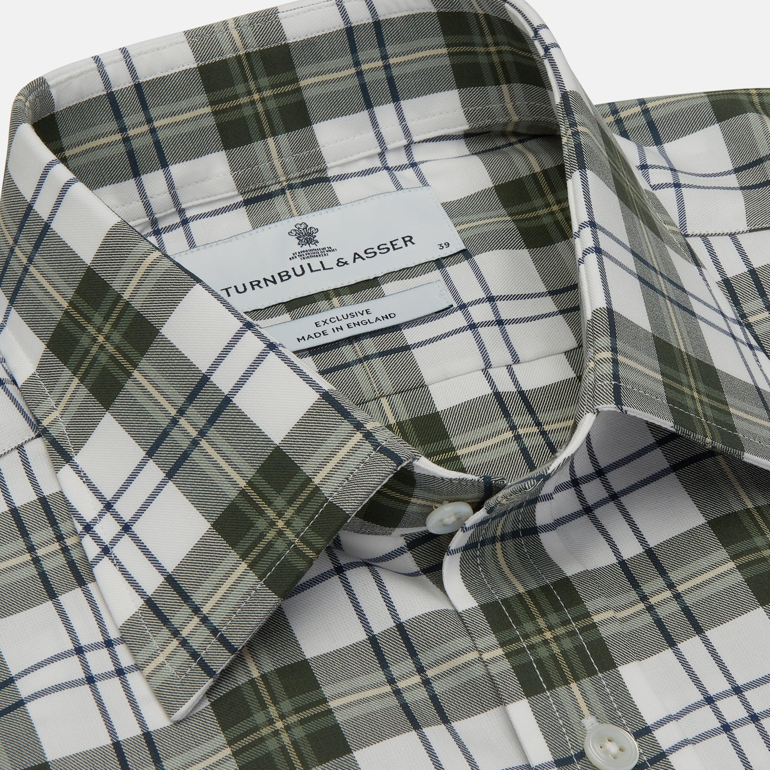 View 4 of product The Turnbull & Asser Green Check Shirt features a classic T&A collar, white buttons down the front and on 3-button cuffs, and a bold green, white, and black plaid pattern.