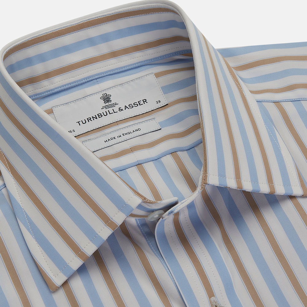 The Turnbull & Asser Blue and Brown Stripe Poplin Shirt features a T&A collar, three-button cuffs, and vertical blue, white, and tan stripes. This smart-casual shirt is displayed on a plain light background.