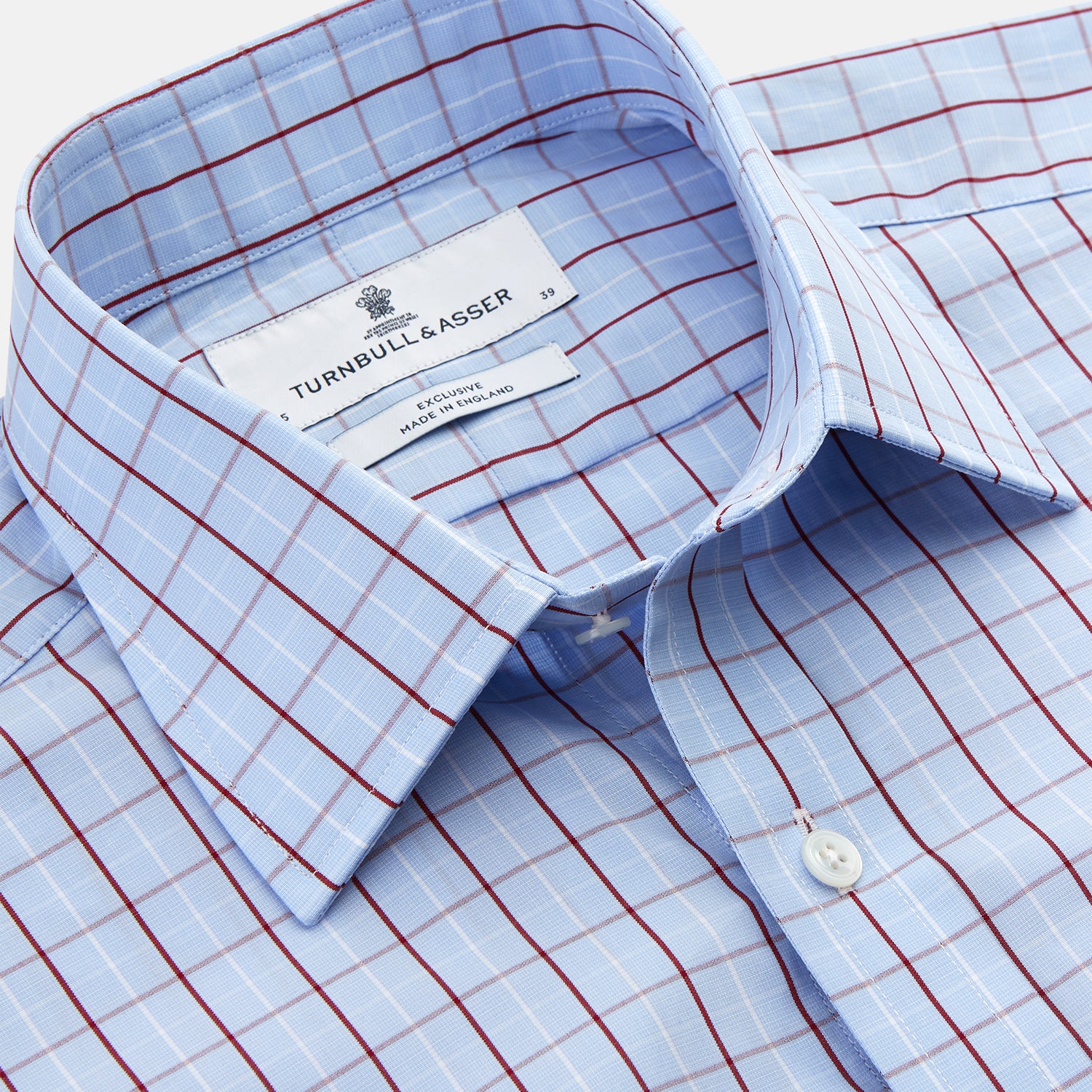 View 2 of product The Burgundy Graph Check Regular Fit Shirt by Turnbull & Asser features a T&A collar, 3-button cuffs, and a check pattern. Laid flat on a white background.