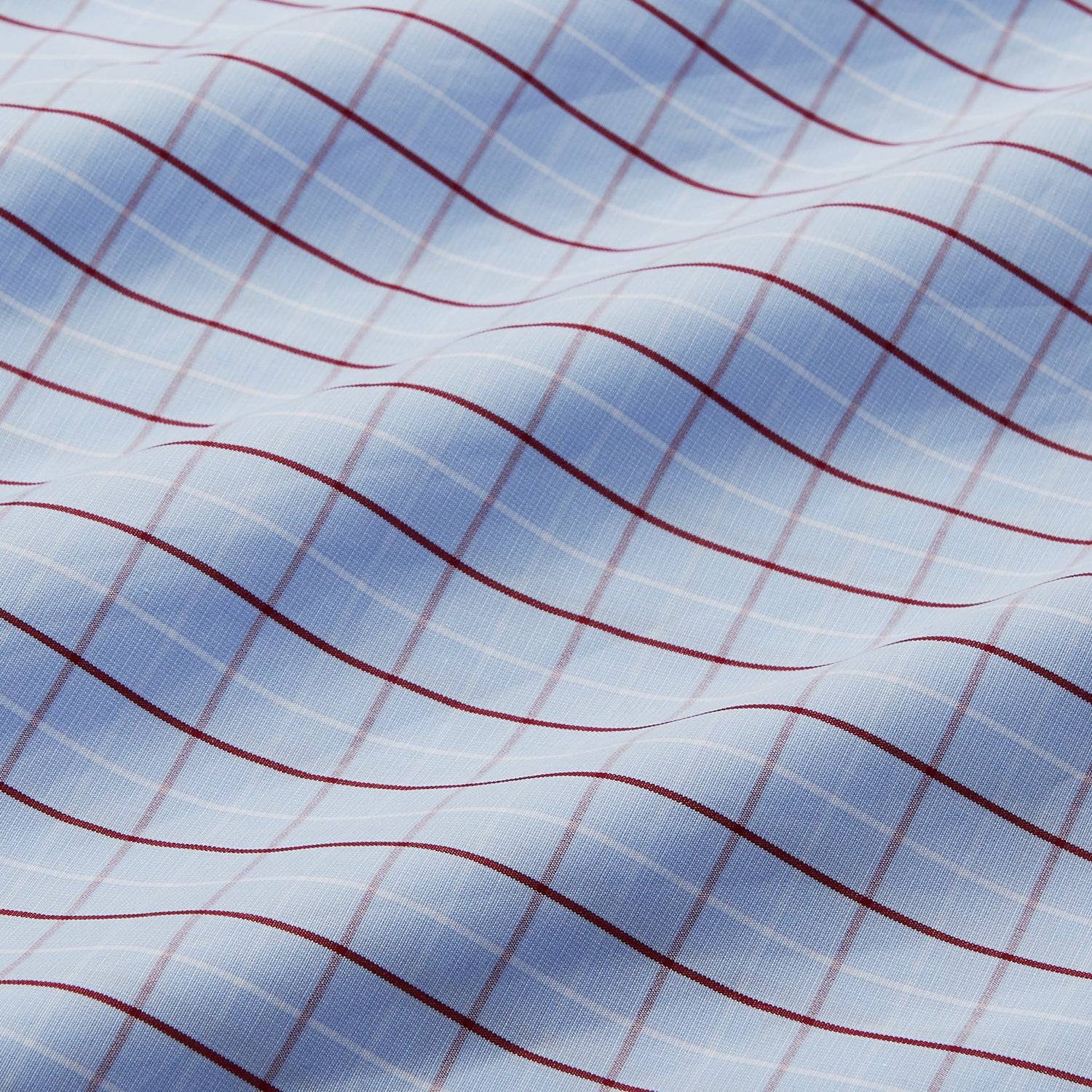 View 4 of product The Burgundy Graph Check Regular Fit Shirt by Turnbull & Asser features a T&A collar, 3-button cuffs, and a check pattern. Laid flat on a white background.