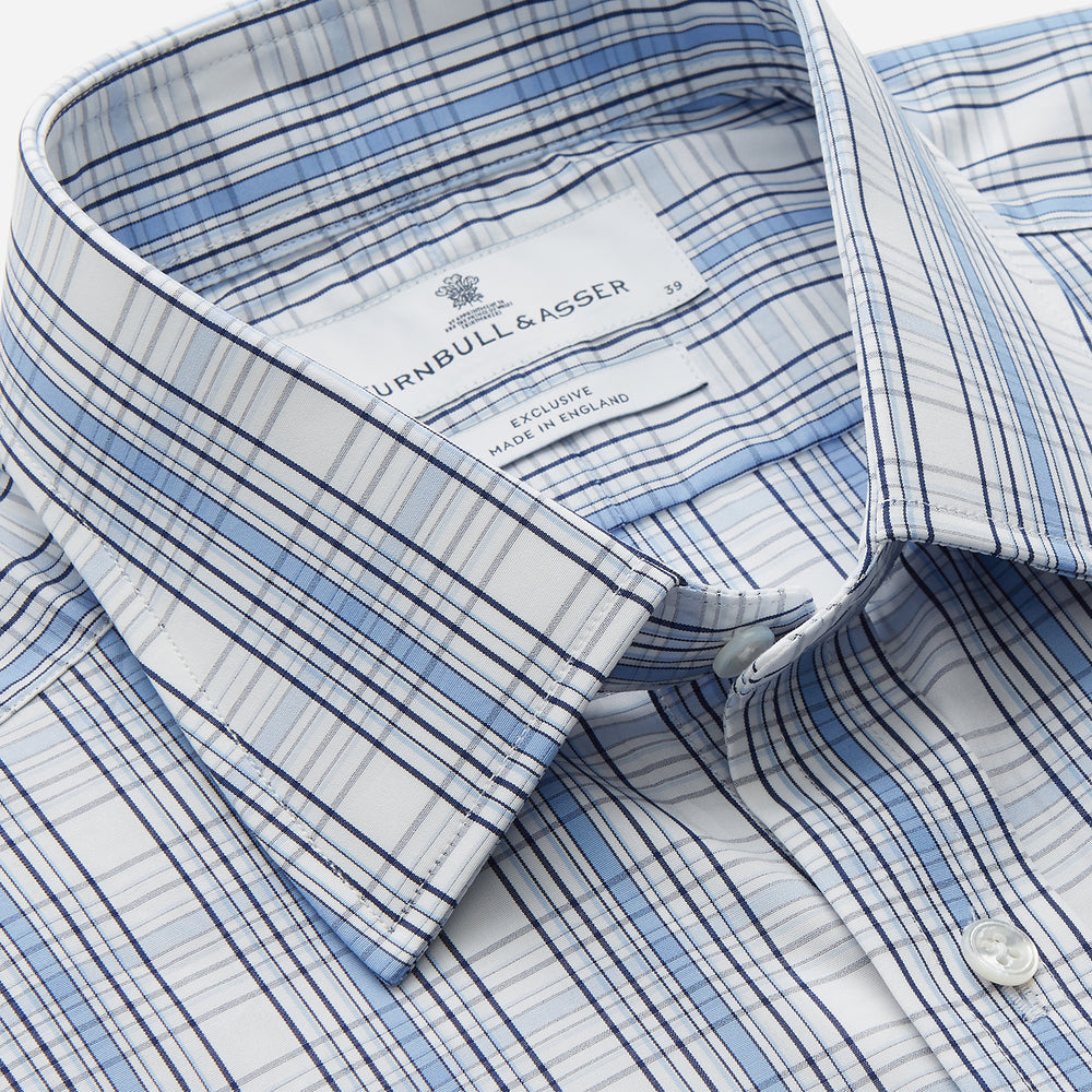 The Turnbull & Asser Tonal Blue Check Regular Fit Shirt with T&A collar and 3-button cuffs is displayed flat on a white background, highlighting its blue and white plaid pattern and long sleeves.