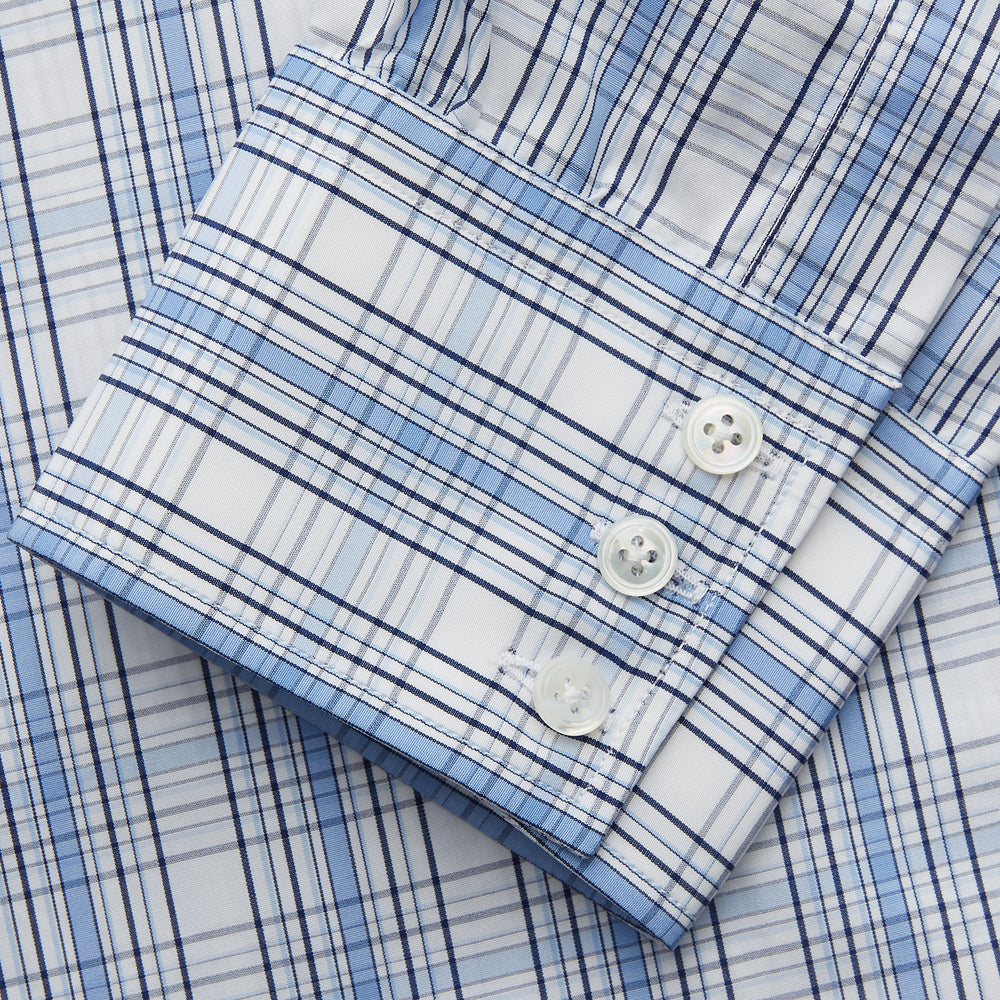 The Turnbull & Asser Tonal Blue Check Regular Fit Shirt with T&A collar and 3-button cuffs is displayed flat on a white background, highlighting its blue and white plaid pattern and long sleeves.
