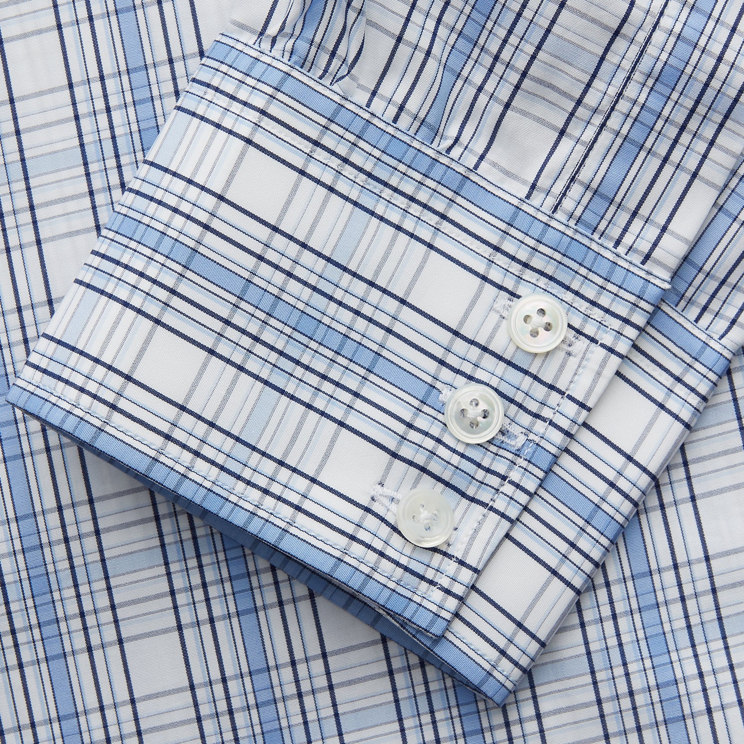 View 3 of product The Turnbull & Asser Tonal Blue Check Regular Fit Shirt with T&A collar and 3-button cuffs is displayed flat on a white background, highlighting its blue and white plaid pattern and long sleeves.