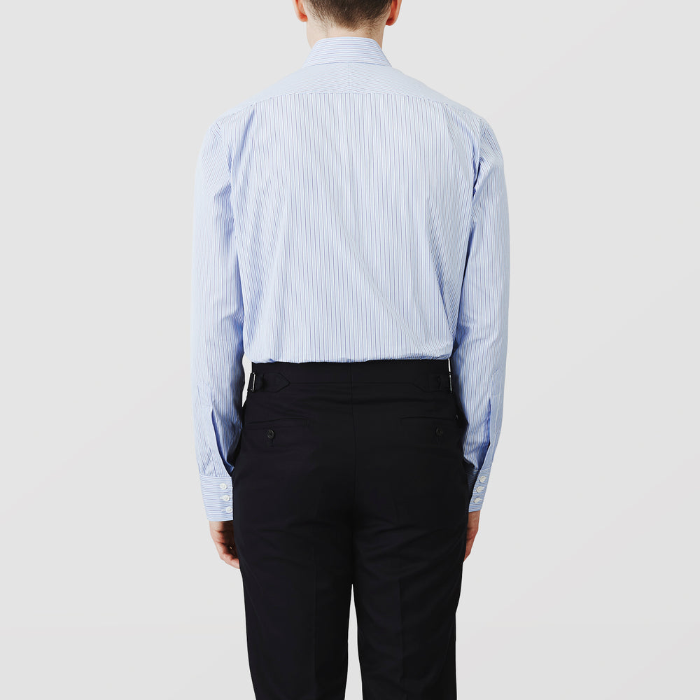 Turnbull & Asser’s Blue Stripe Shirt features thin vertical white stripes, a T&A collar, 3-button cuffs, white buttons, and a regular fit. Smart-casual style displayed flat on a white background.