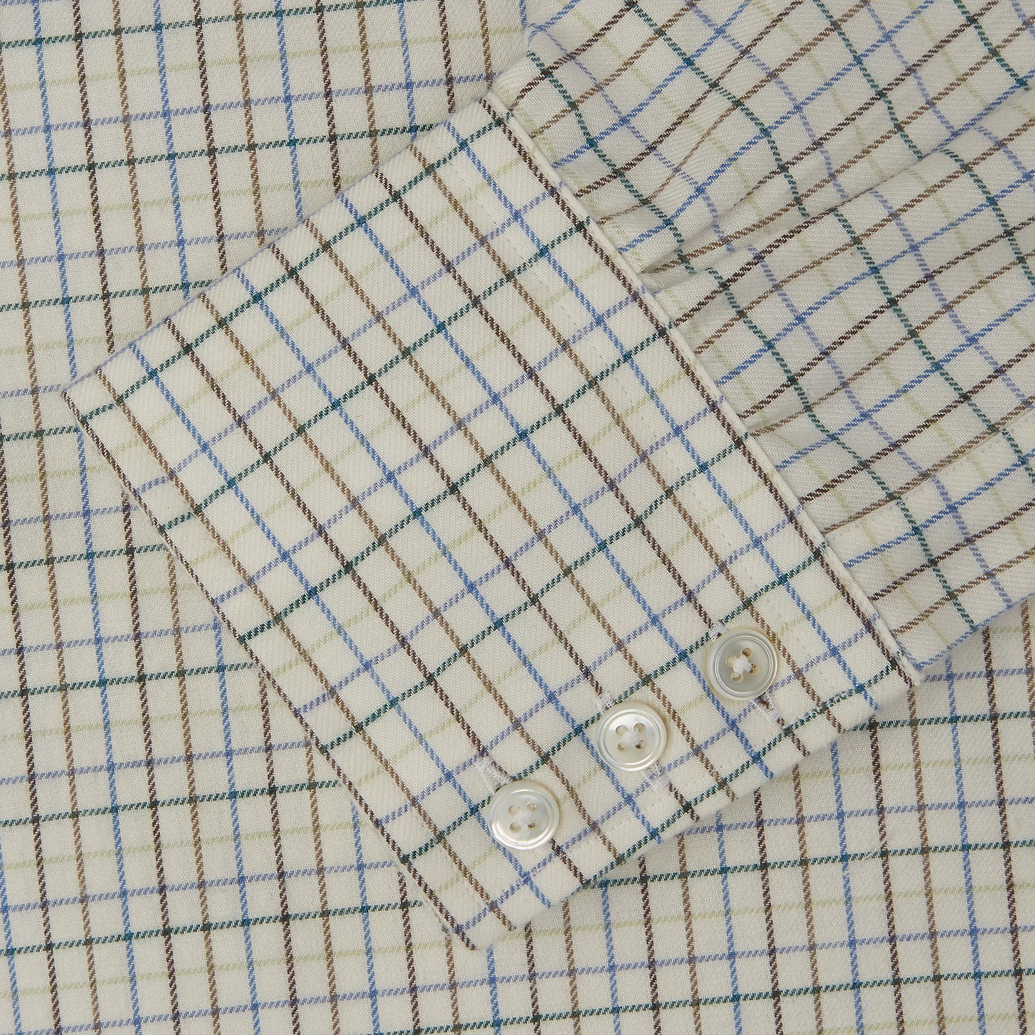 View 5 of product The Turnbull & Asser Green Multi Check Cotton-Cashmere Shirt features a T&A collar, 3-button cuffs, and a tonal green, beige, and blue check pattern. Shown flat against a white background.