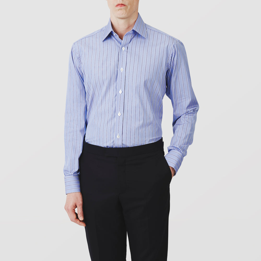 A neatly folded Turnbull & Asser Blue Stripe Regular Fit Shirt with T&A collar and square double cuffs, featuring long sleeves and thin white stripes on a light blue base, displayed on a plain white background.