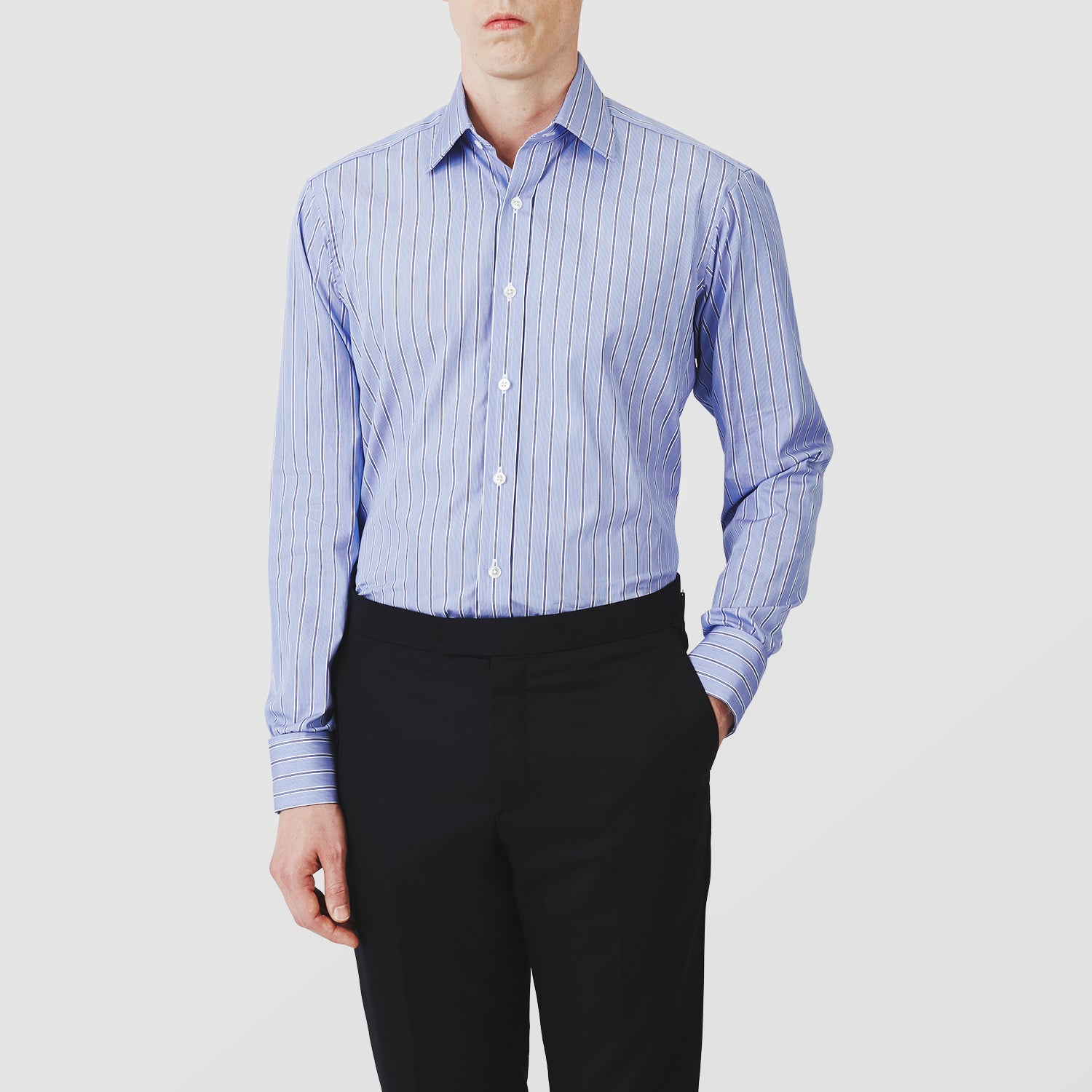View 2 of product A neatly folded Turnbull & Asser Blue Stripe Regular Fit Shirt with T&A collar and square double cuffs, featuring long sleeves and thin white stripes on a light blue base, displayed on a plain white background.