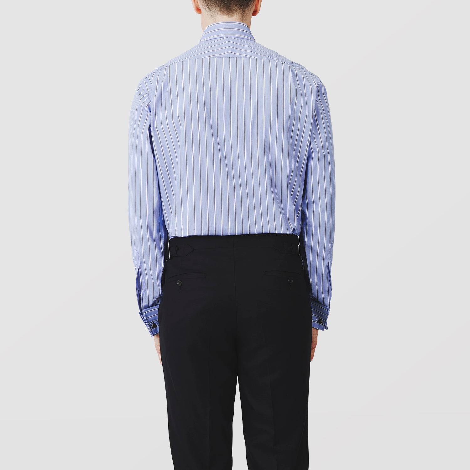 View 3 of product A neatly folded Turnbull & Asser Blue Stripe Regular Fit Shirt with T&A collar and square double cuffs, featuring long sleeves and thin white stripes on a light blue base, displayed on a plain white background.