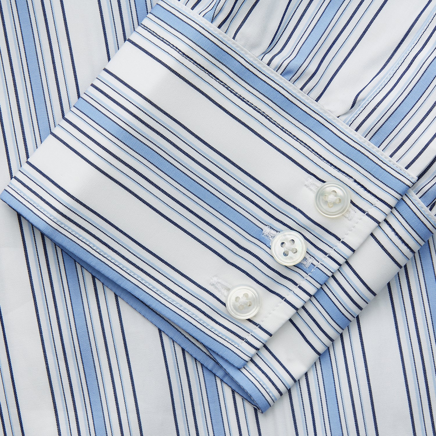 View 3 of product The Turnbull & Asser Blue Multi Stripe Regular Fit Shirt features a classic T&A collar, long sleeves, button-down front, and 3 button cuffs. Shown laid flat against a white background.