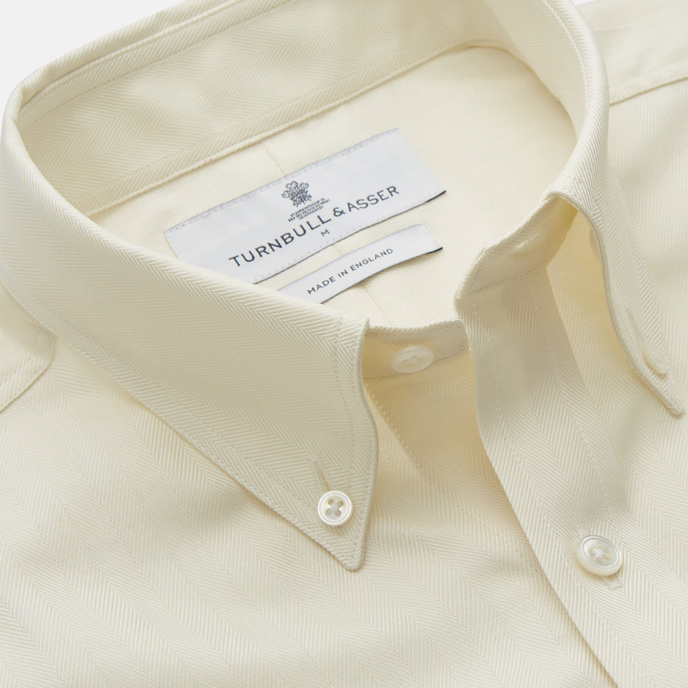 The Cream Herringbone Fine Cotton Weekend Officer Fit Shirt by Turnbull & Asser features a Dorset collar, long sleeves, two button-flap chest pockets, and buttoned cuffs—perfect for smart-casual style.