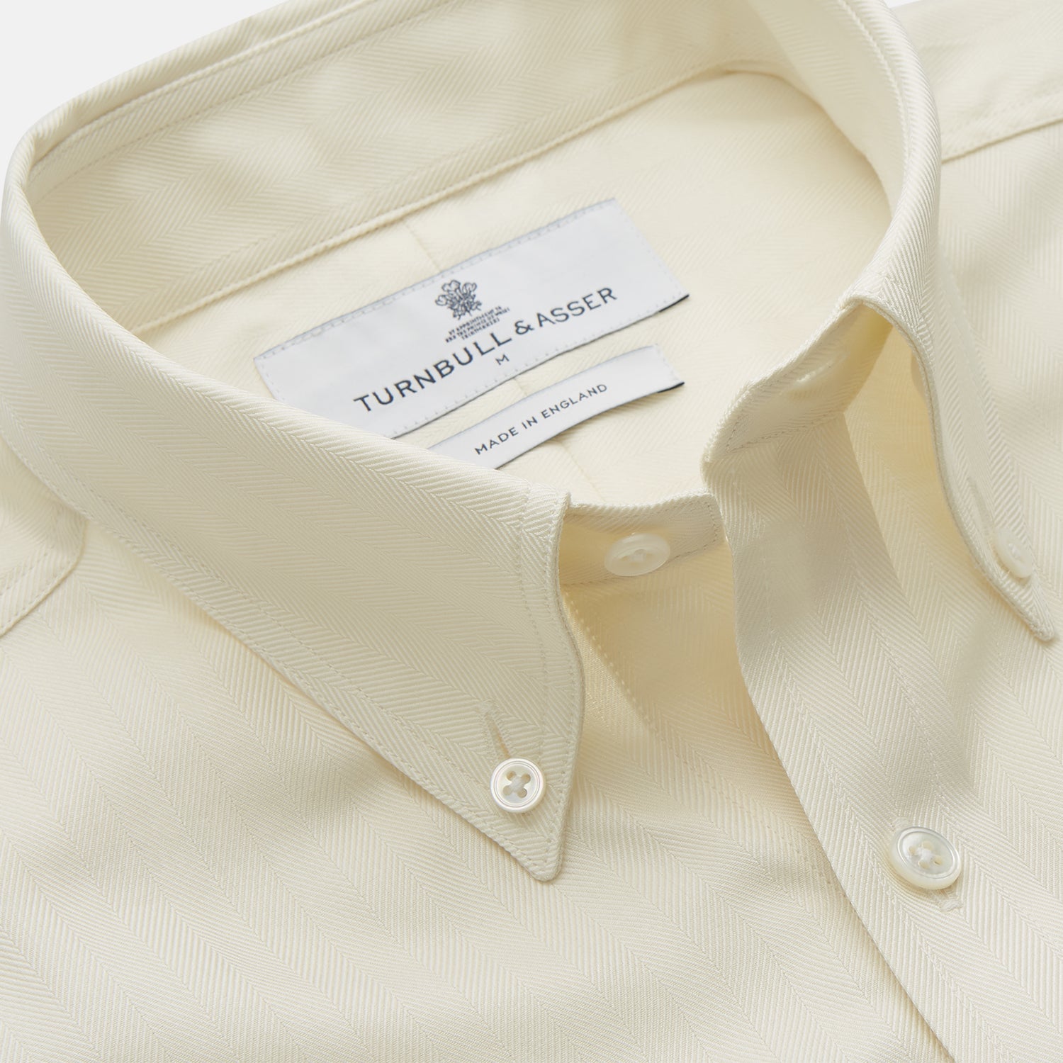 View 2 of product The Cream Herringbone Fine Cotton Weekend Officer Fit Shirt by Turnbull & Asser features a Dorset collar, long sleeves, two button-flap chest pockets, and buttoned cuffs—perfect for smart-casual style.