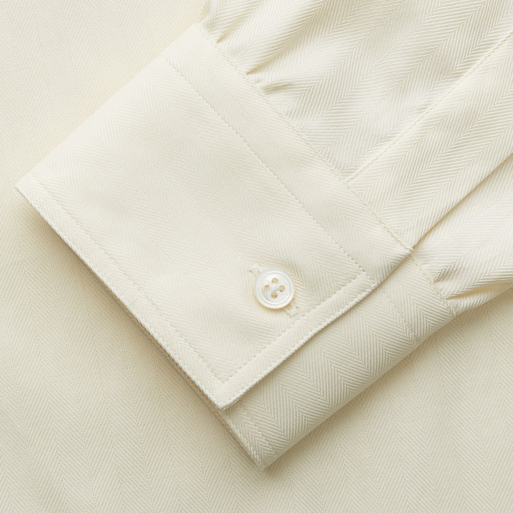 The Cream Herringbone Fine Cotton Weekend Officer Fit Shirt by Turnbull & Asser features a Dorset collar, long sleeves, two button-flap chest pockets, and buttoned cuffs—perfect for smart-casual style.