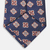 View 4 of product The Turnbull & Asser Burgundy Geometric Jacquard Tie features a bold, playful pattern of red and white dice scattered across its surface.
