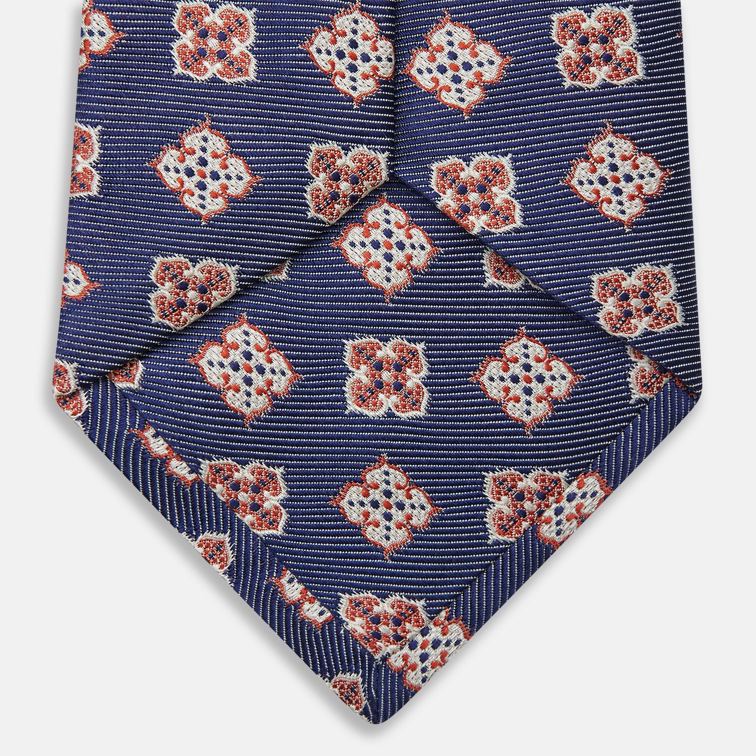 View 4 of product The Turnbull & Asser Burgundy Geometric Jacquard Tie features a bold, playful pattern of red and white dice scattered across its surface.