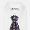 View 2 of product The Turnbull & Asser Burgundy Geometric Jacquard Tie features a bold, playful pattern of red and white dice scattered across its surface.