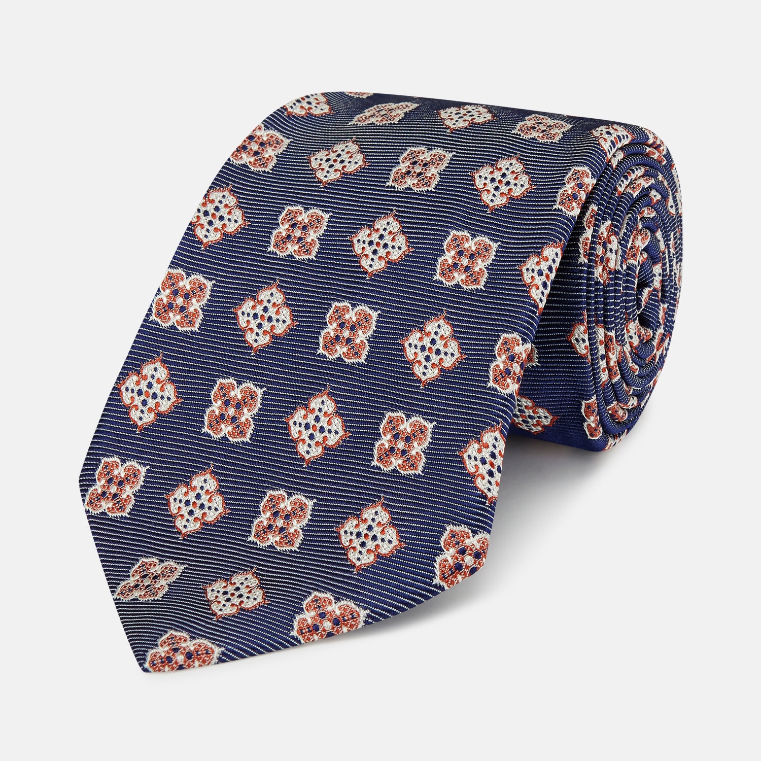 View 1 of product The Turnbull & Asser Burgundy Geometric Jacquard Tie features a bold, playful pattern of red and white dice scattered across its surface.