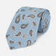 The Turnbull & Asser Sky Blue Renoir Paisley Tie, crafted in silk with a repeating navy and beige pattern, is shown rolled up with its pointed end forward on a plain white background.