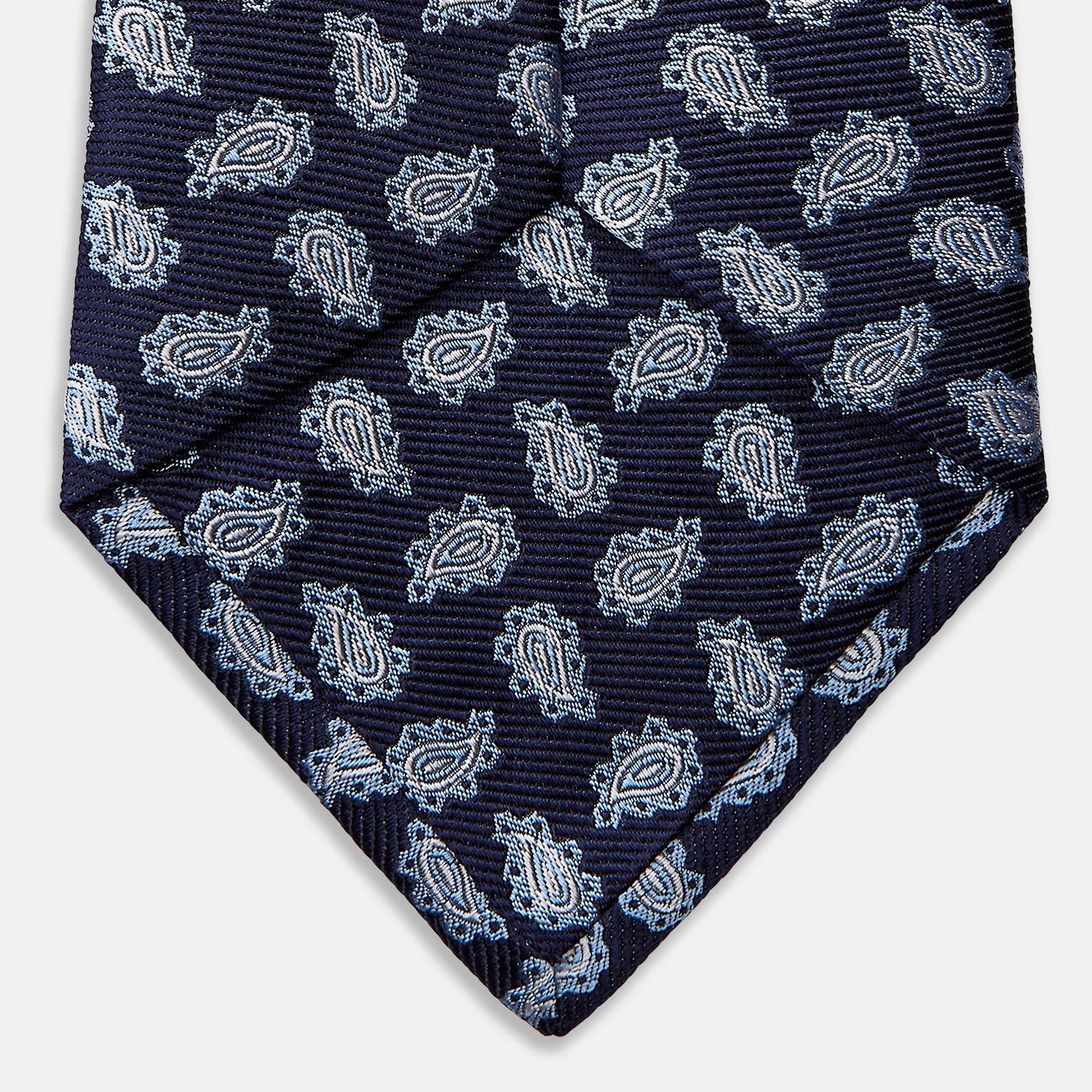 View 4 of product The Blue Abstract Paisley Silk Tie by Turnbull & Asser features a classic paisley motif in navy, offering a timeless touch to your wardrobe and perfectly capturing traditional elegance.