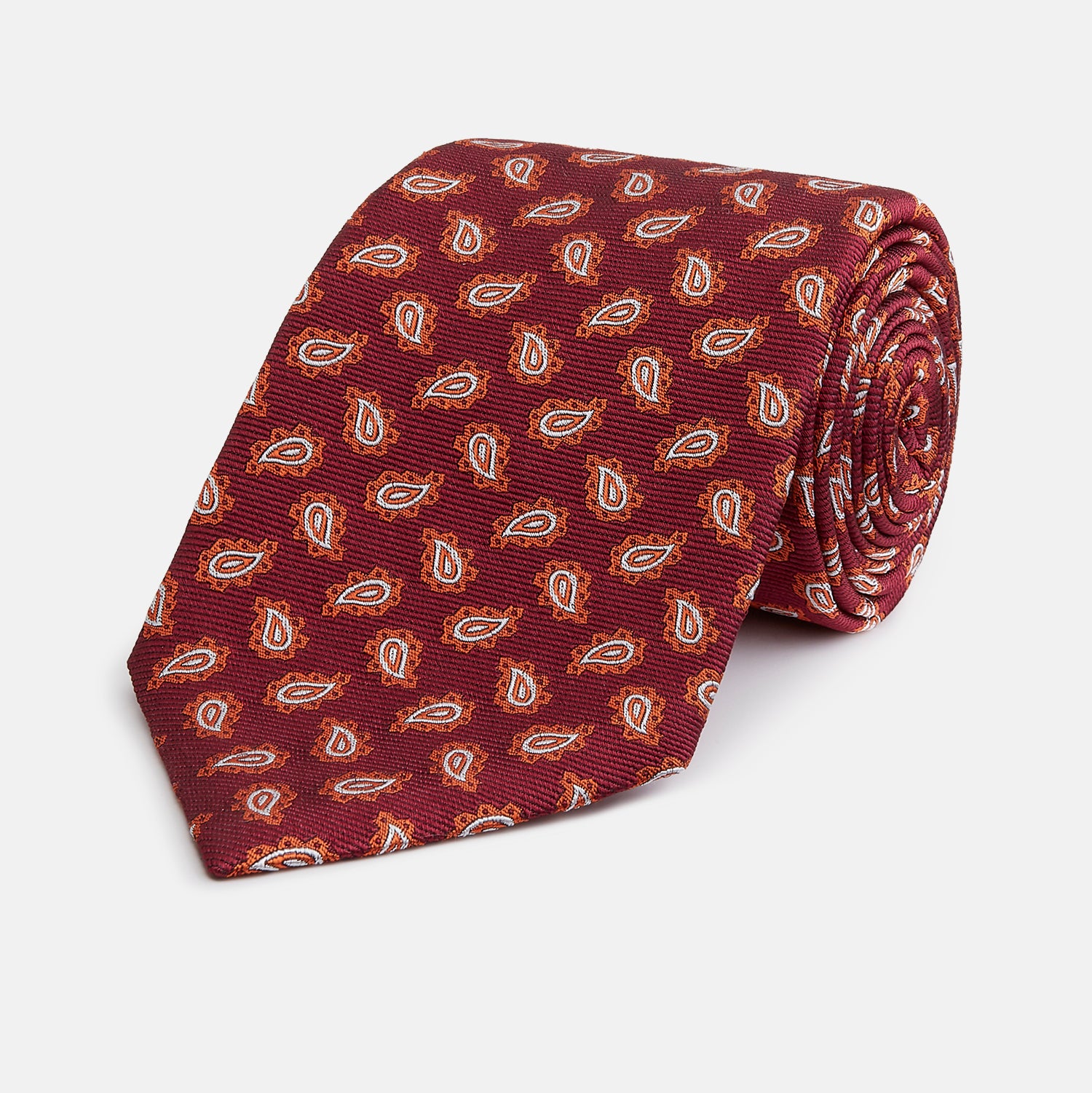 View 1 of product The Turnbull & Asser Red Abstract Paisley Silk Tie features bold orange and white paisley patterns on rich red silk—a stylish choice for fans of classic tailoring.
