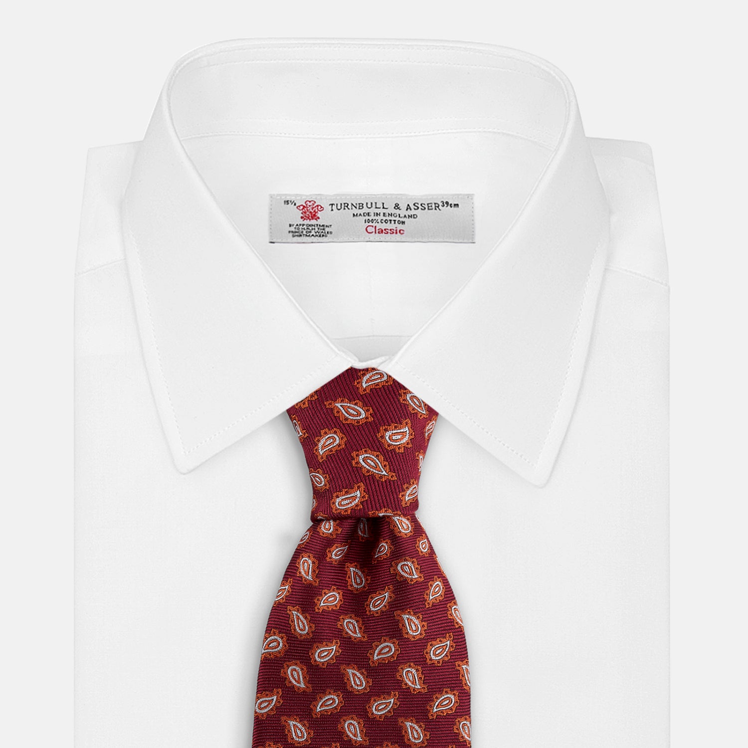 View 2 of product The Turnbull & Asser Red Abstract Paisley Silk Tie features bold orange and white paisley patterns on rich red silk—a stylish choice for fans of classic tailoring.