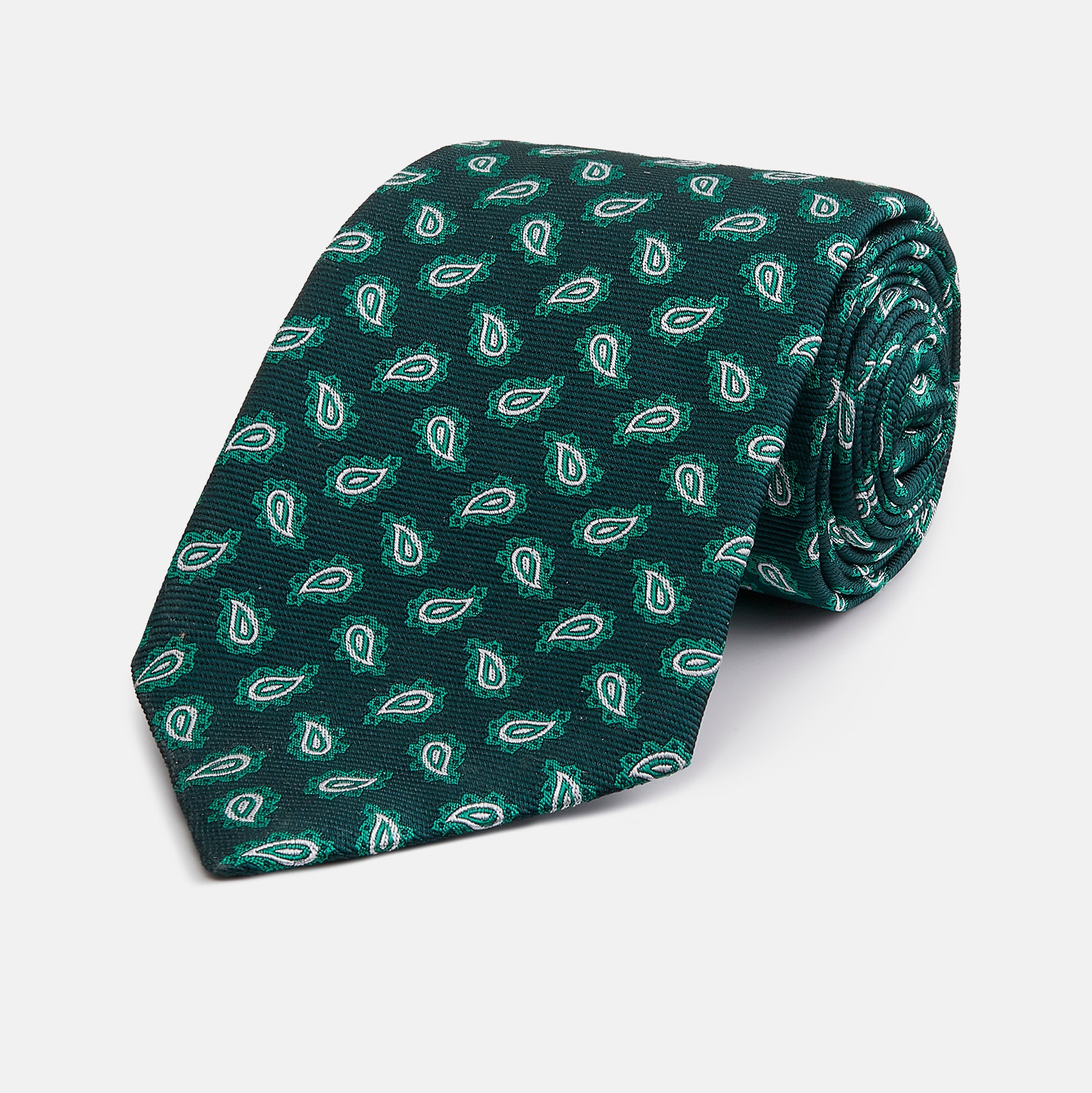 View 1 of product The Turnbull & Asser Green Abstract Paisley Silk Tie features a repeating light green paisley pattern on dark green silk, shown rolled up against a white background—a refined men’s accessory for making a statement.