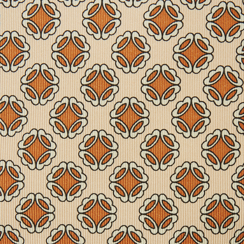 A cream floral geometric tie by Turnbull & Asser, rolled with the pointed end forward, is displayed on a white background.