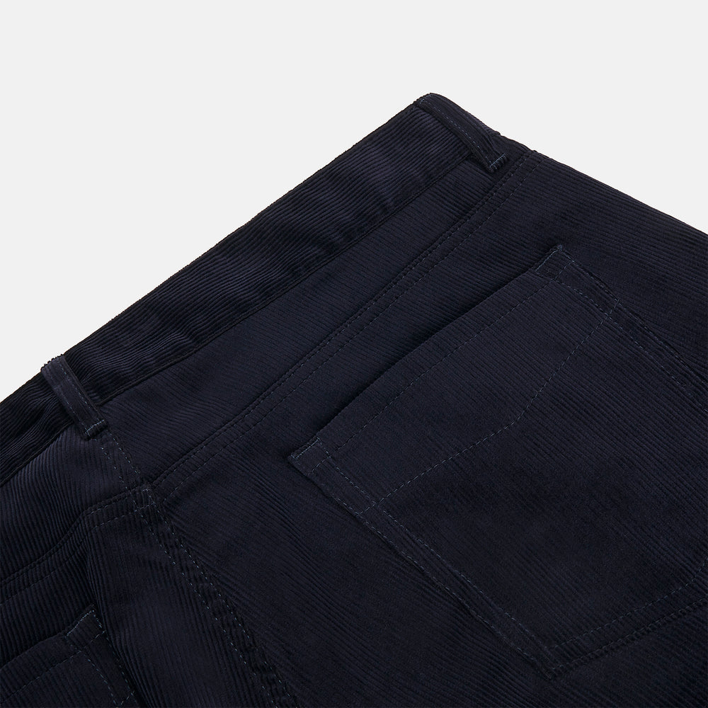 A pair of navy twill cotton five-pocket trousers from Turnbull & Asser, shown laid flat against a white background.