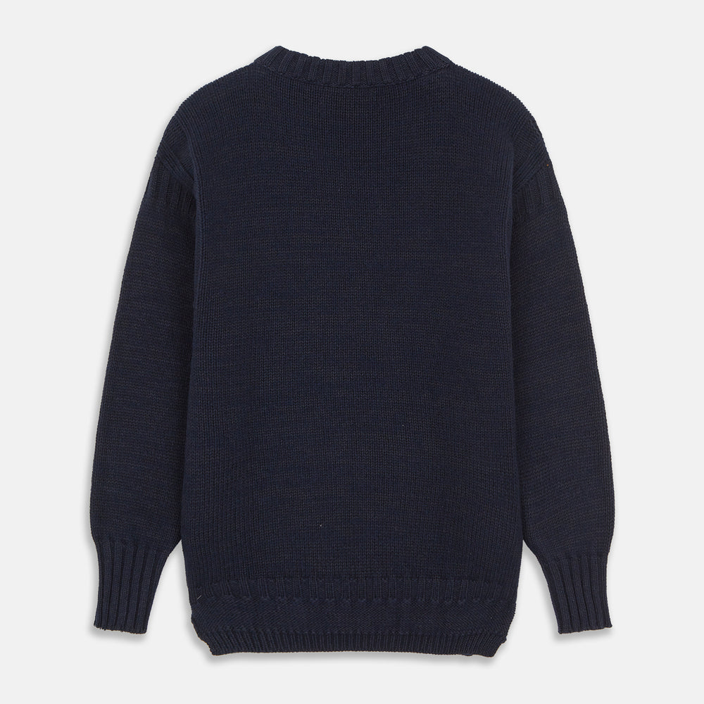 A man stands in the Turnbull & Asser Navy Lewis Guernsey Knitted Jumper.