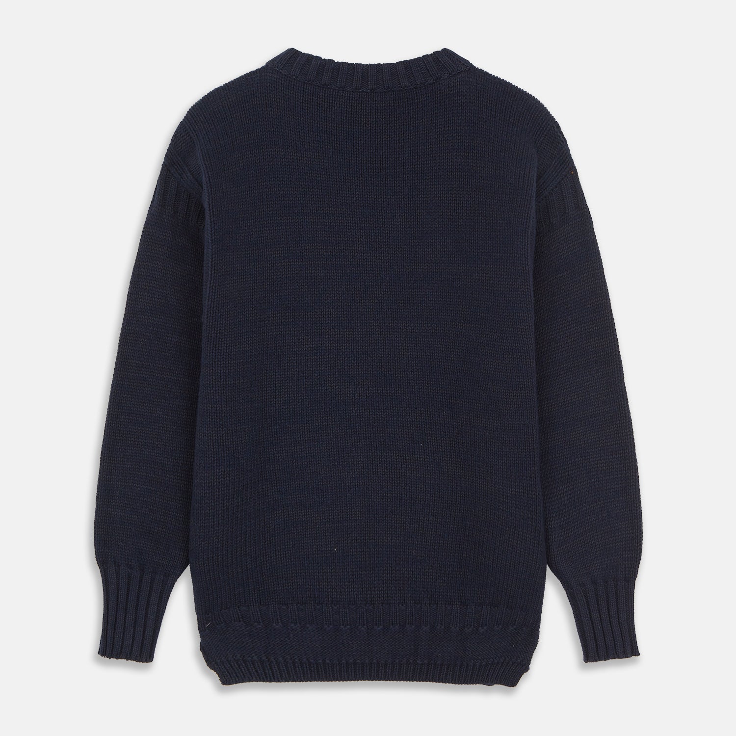 View 6 of product A man stands in the Turnbull & Asser Navy Lewis Guernsey Knitted Jumper.