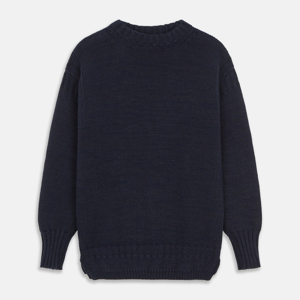 A man stands in the Turnbull & Asser Navy Lewis Guernsey Knitted Jumper.