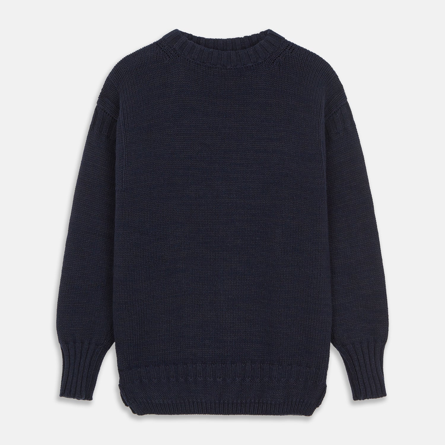 View 2 of product A man stands in the Turnbull & Asser Navy Lewis Guernsey Knitted Jumper.