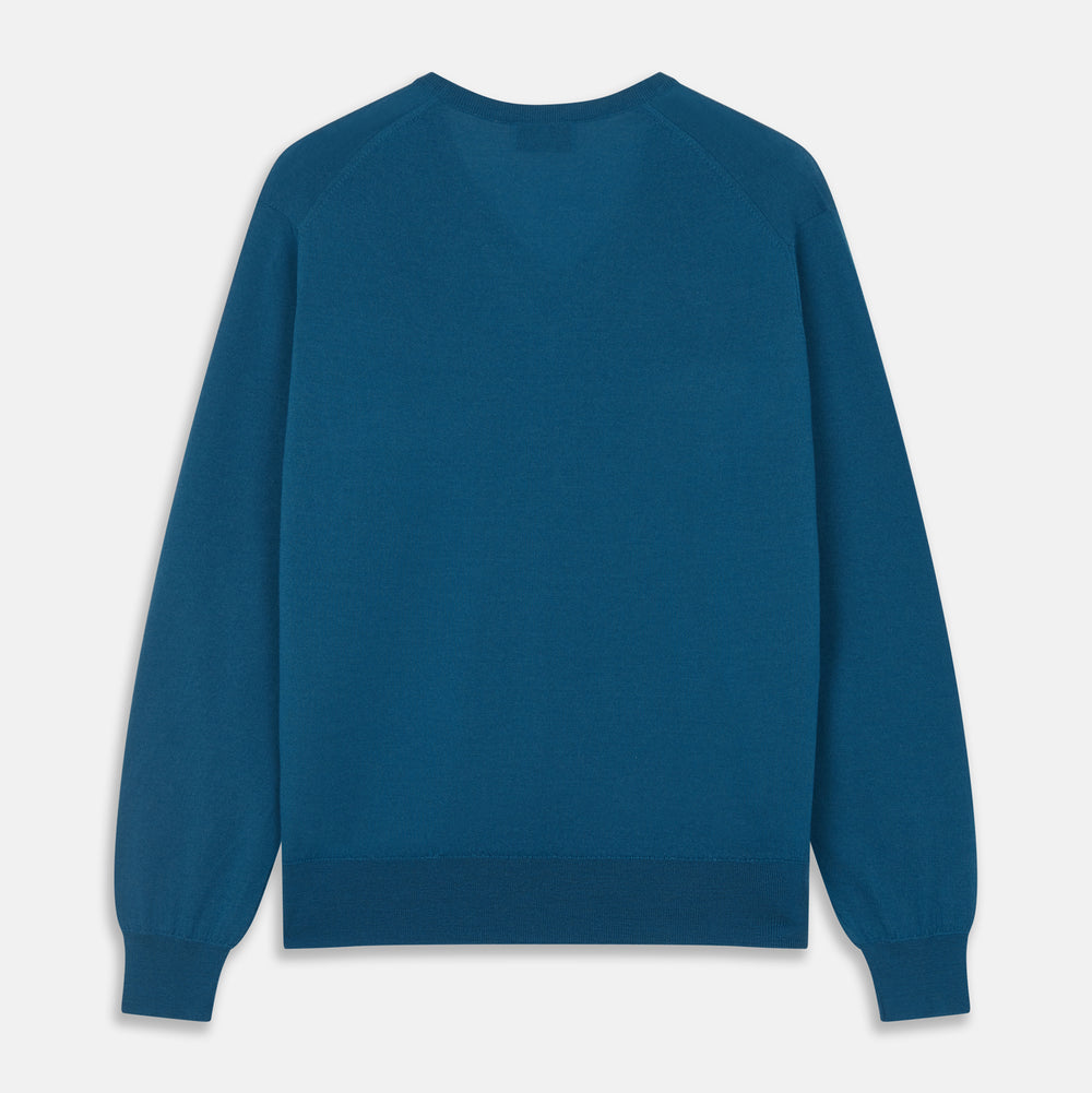 The Turnbull & Asser Ocean Blue Merino Kennedy V-Neck Jumper, shown flat on a white background, features ribbed cuffs and hem with a visible branded label at the neckline.
