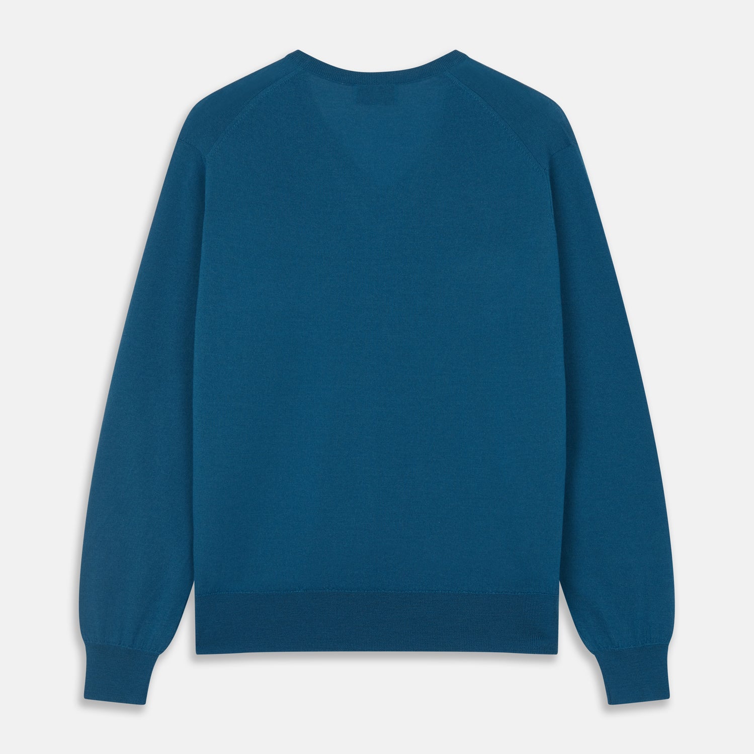 View 3 of product The Turnbull & Asser Ocean Blue Merino Kennedy V-Neck Jumper, shown flat on a white background, features ribbed cuffs and hem with a visible branded label at the neckline.
