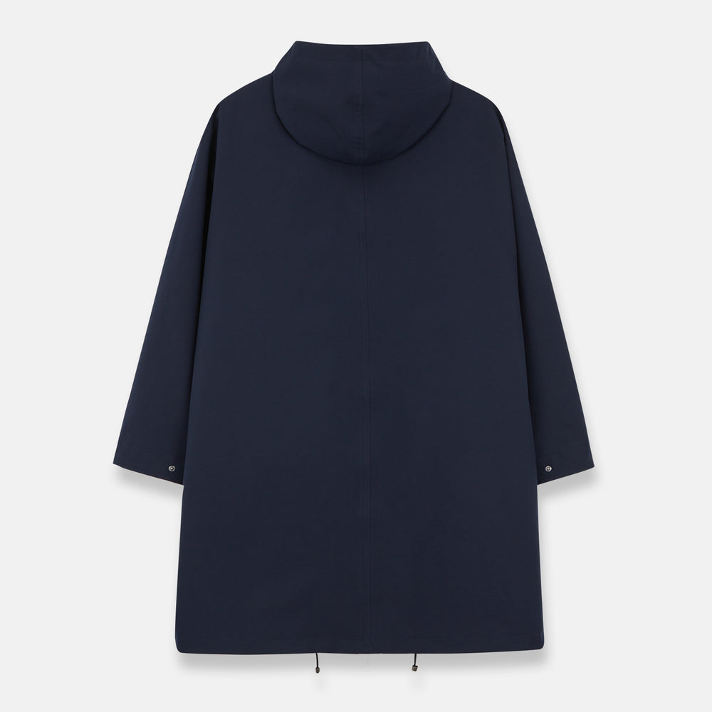 The Turnbull & Asser Navy Walter Sealup Parka with Detachable Liner features silver snap buttons, front flap pockets, and a drawstring hem. Styled against a white background, this waterproof parka offers both elegance and practicality for wet weather.