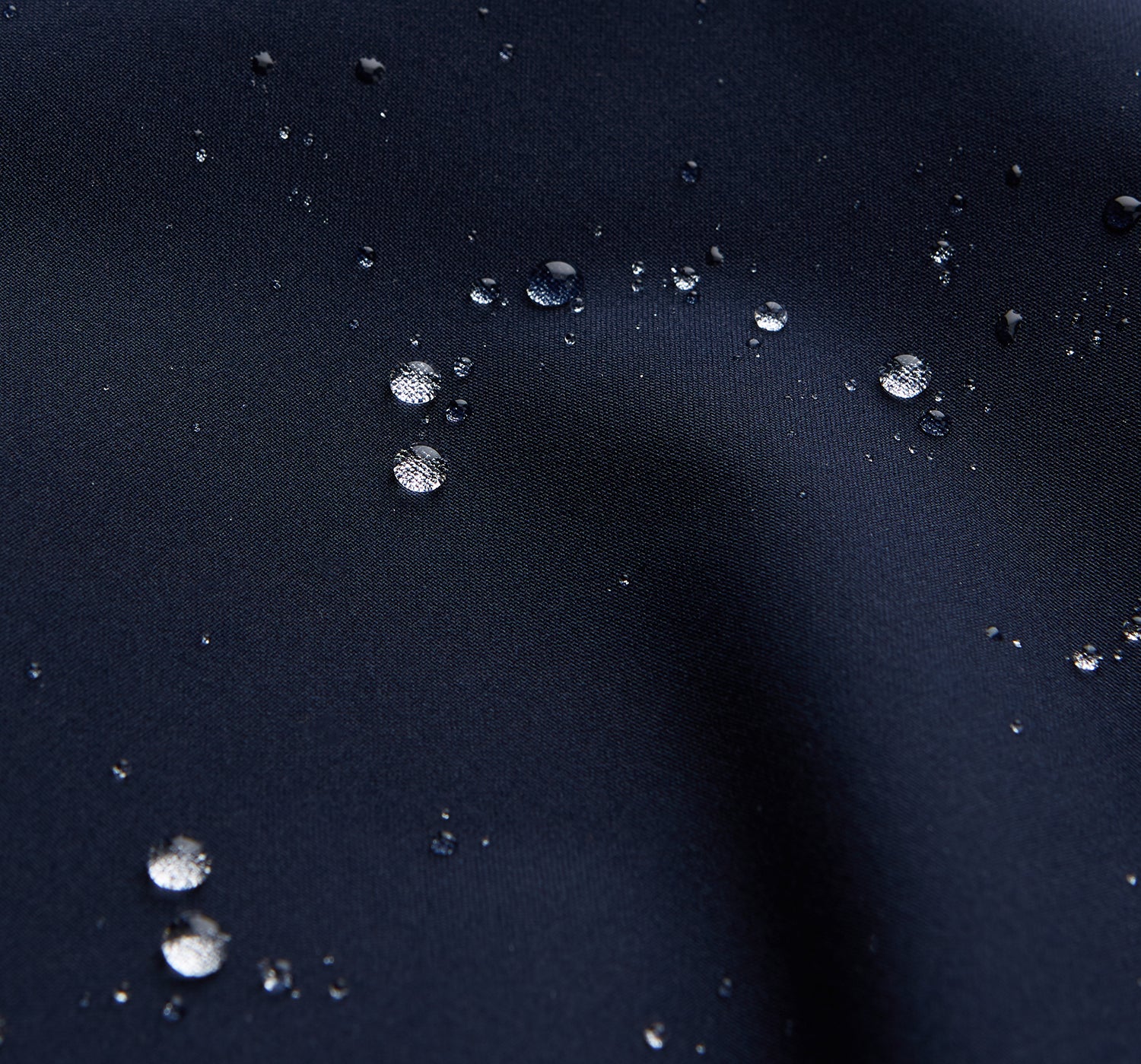 View 5 of product The Turnbull & Asser Navy Walter Sealup Parka with Detachable Liner features silver snap buttons, front flap pockets, and a drawstring hem. Styled against a white background, this waterproof parka offers both elegance and practicality for wet weather.