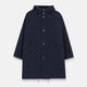 The Turnbull & Asser Navy Walter Sealup Parka with Detachable Liner features silver snap buttons, front flap pockets, and a drawstring hem. Styled against a white background, this waterproof parka offers both elegance and practicality for wet weather.