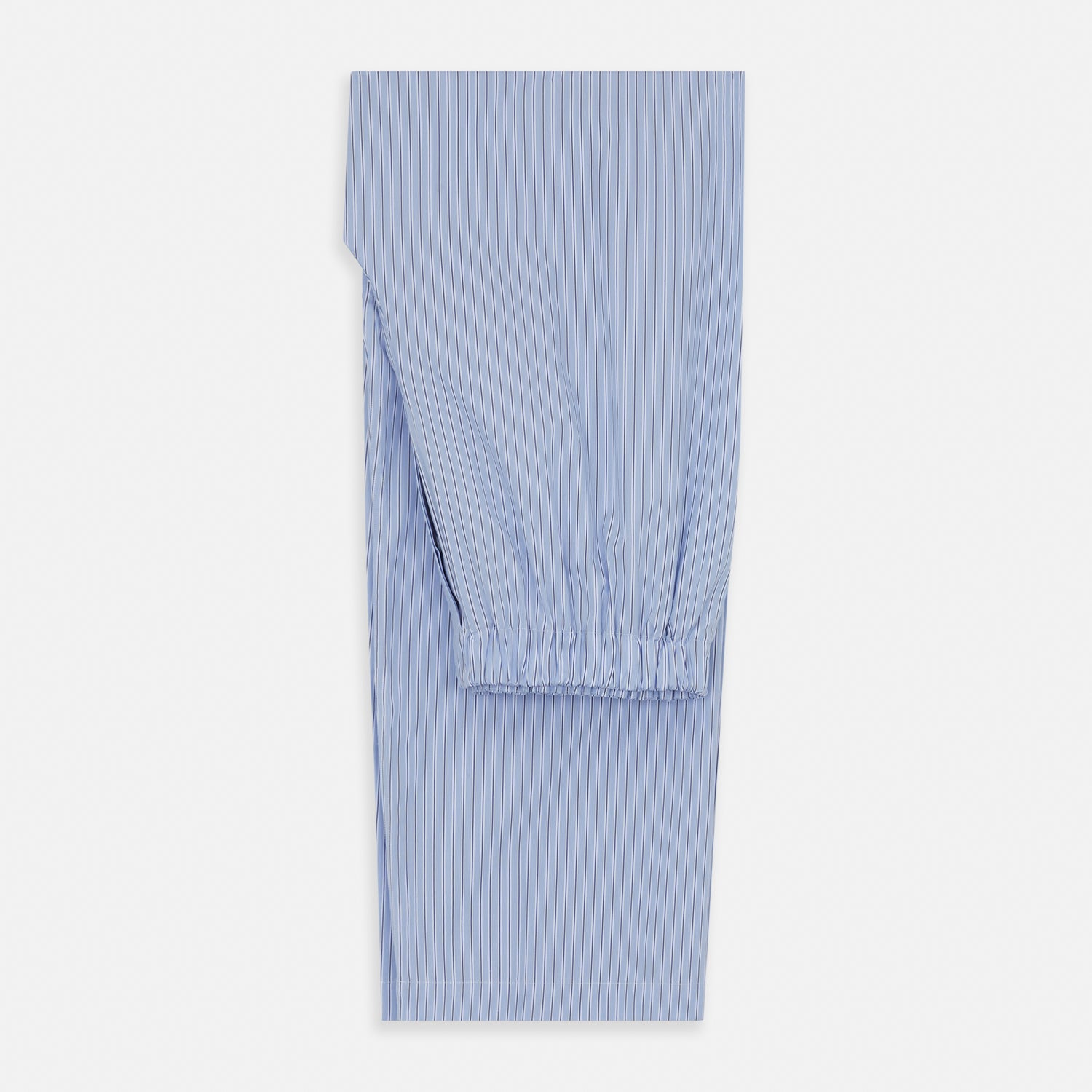 View 5 of product A man stands barefoot against a plain background, wearing a white short-sleeve T-shirt and Turnbull & Asser Blue Stripe Cotton Pyjama Trousers in a contemporary fit, looking straight ahead with a neutral expression.