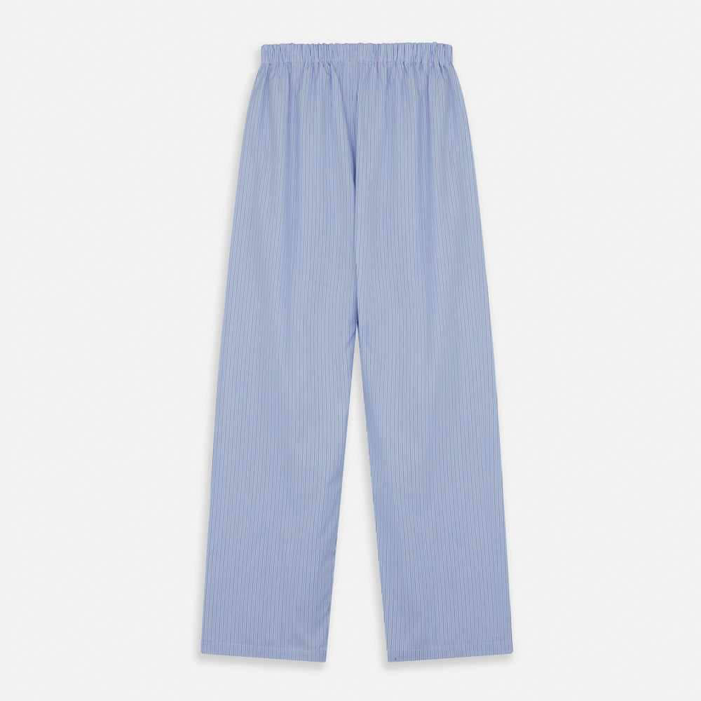 A man stands barefoot against a plain background, wearing a white short-sleeve T-shirt and Turnbull & Asser Blue Stripe Cotton Pyjama Trousers in a contemporary fit, looking straight ahead with a neutral expression.
