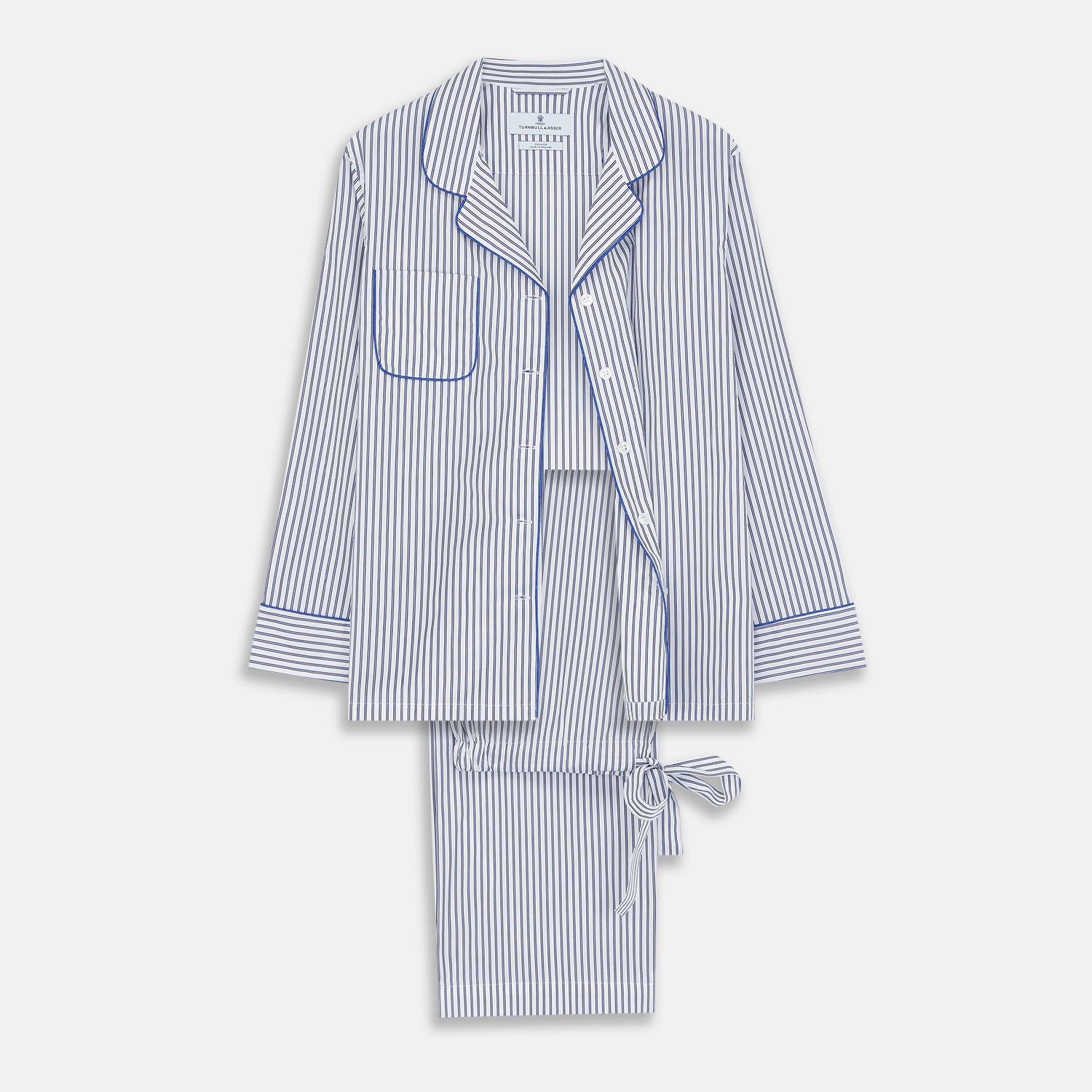 View 1 of product The Women's Dara Navy Stripe Pyjama Set by Turnbull & Asser features a long-sleeve button-up shirt with chest pocket and drawstring pants in premium cotton, shown neatly on a white background.