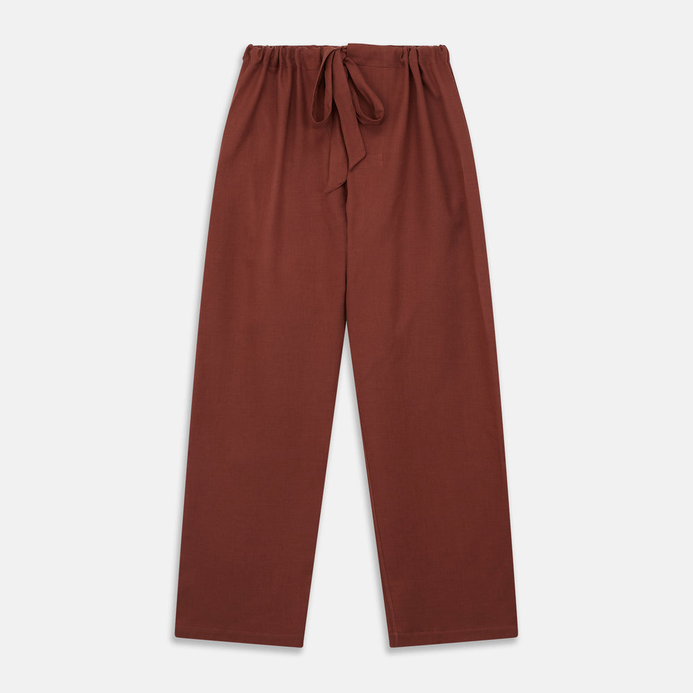 The Turnbull & Asser Red Cotton-Cashmere Pyjama Set features a rust-red long-sleeve button-up top with chest pocket and matching waist-tied pants, shown on a plain white background.