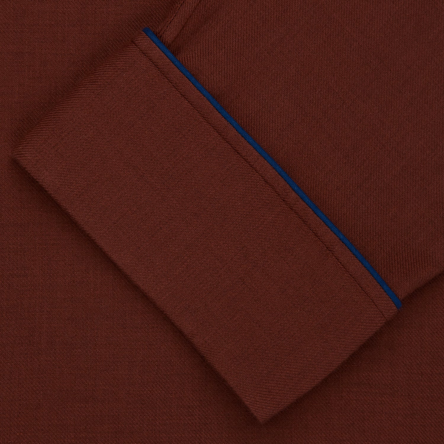 View 4 of product The Turnbull & Asser Red Cotton-Cashmere Pyjama Set features a rust-red long-sleeve button-up top with chest pocket and matching waist-tied pants, shown on a plain white background.