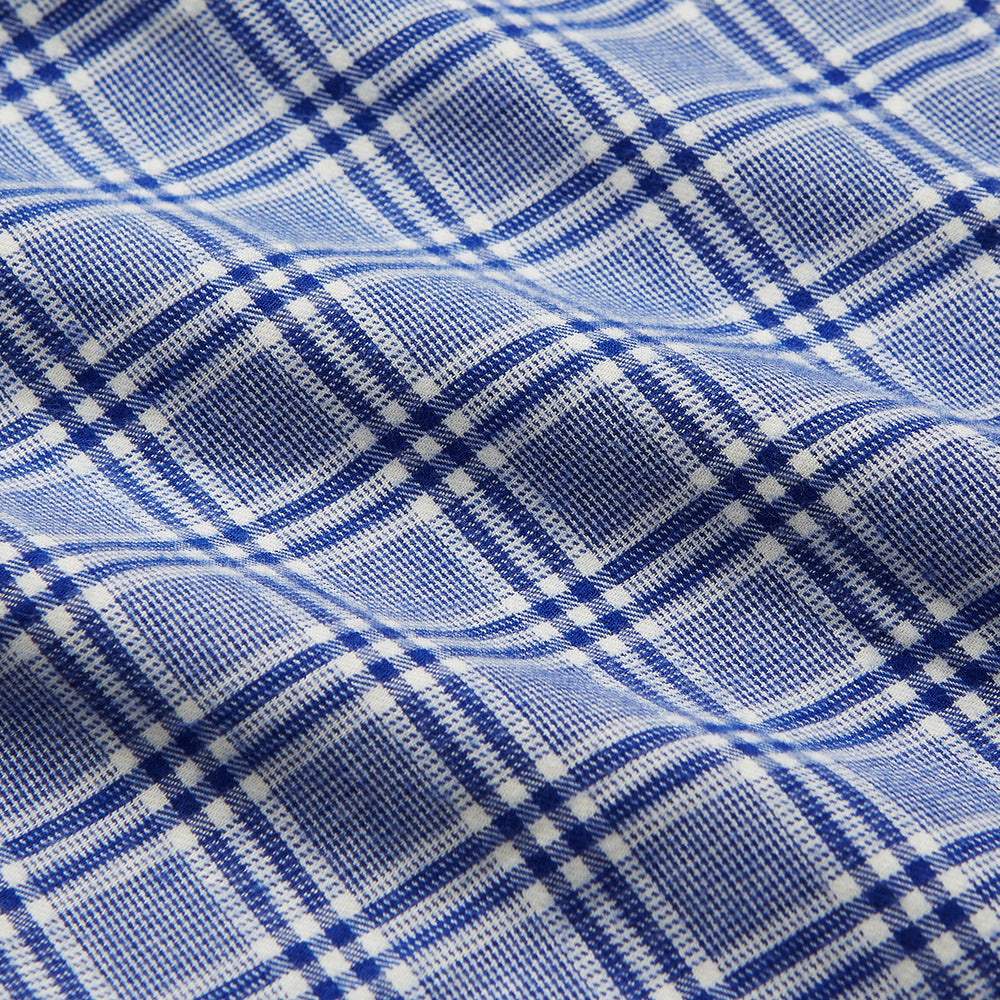 The Turnbull & Asser Blue Check Modern Cotton Pyjama Set features a long-sleeve button-up top and matching pants, crafted from thicker cotton for added comfort, shown against a white background.