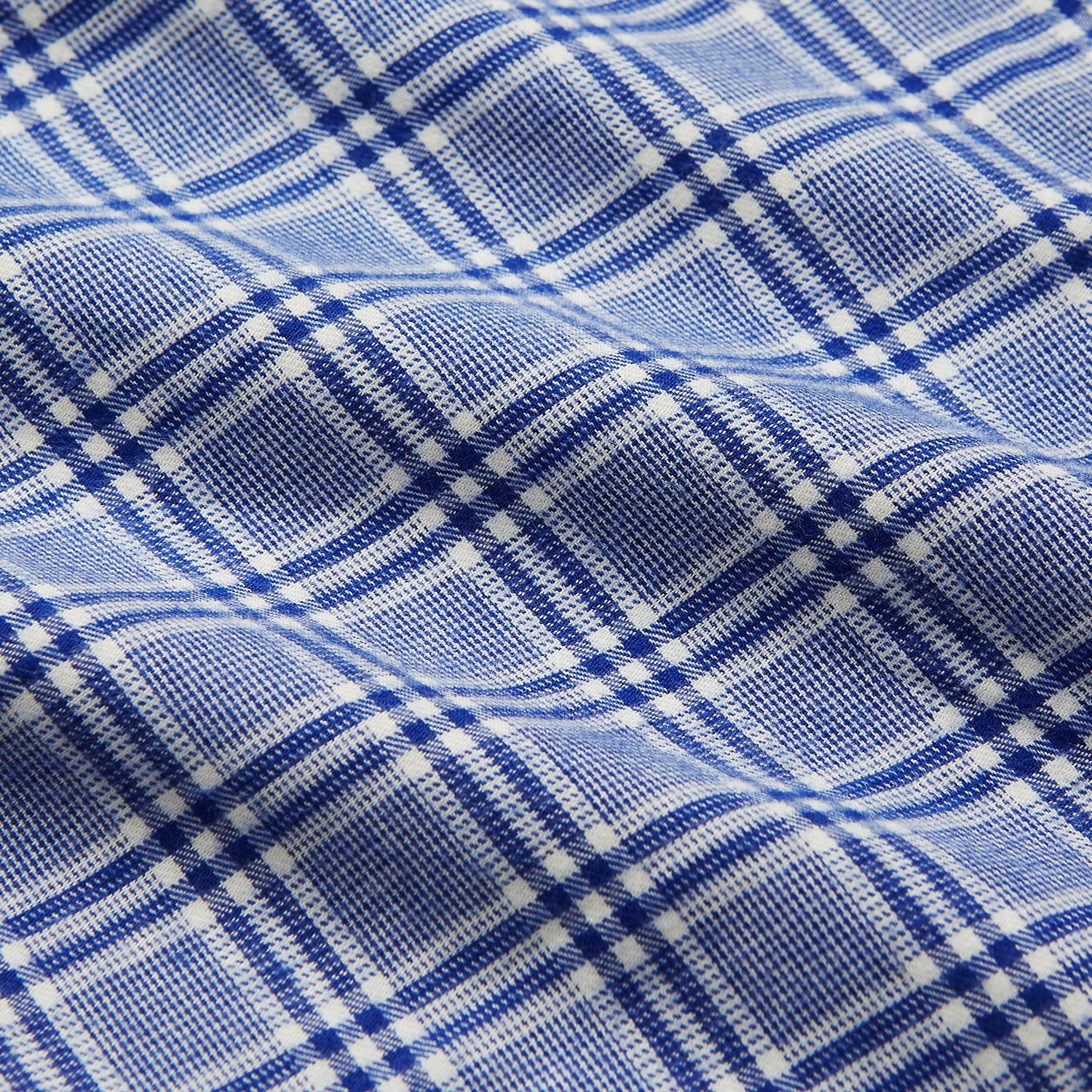 View 4 of product The Turnbull & Asser Blue Check Modern Cotton Pyjama Set features a long-sleeve button-up top and matching pants, crafted from thicker cotton for added comfort, shown against a white background.