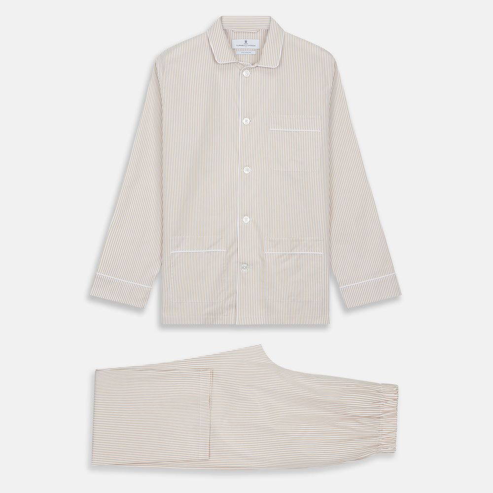 The Turnbull & Asser Sand Bengal Stripe Modern Fit Cotton Pyjama Set features cream-colored striped Italian cotton, with a long-sleeved button-up top and matching drawstring pants, neatly displayed against a white background.