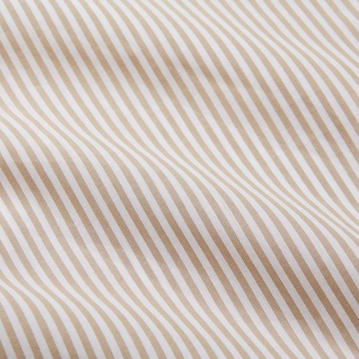 View 4 of product The Turnbull & Asser Sand Bengal Stripe Modern Fit Cotton Pyjama Set features cream-colored striped Italian cotton, with a long-sleeved button-up top and matching drawstring pants, neatly displayed against a white background.