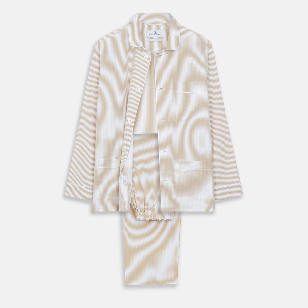 The Turnbull & Asser Sand Bengal Stripe Modern Fit Cotton Pyjama Set features cream-colored striped Italian cotton, with a long-sleeved button-up top and matching drawstring pants, neatly displayed against a white background.